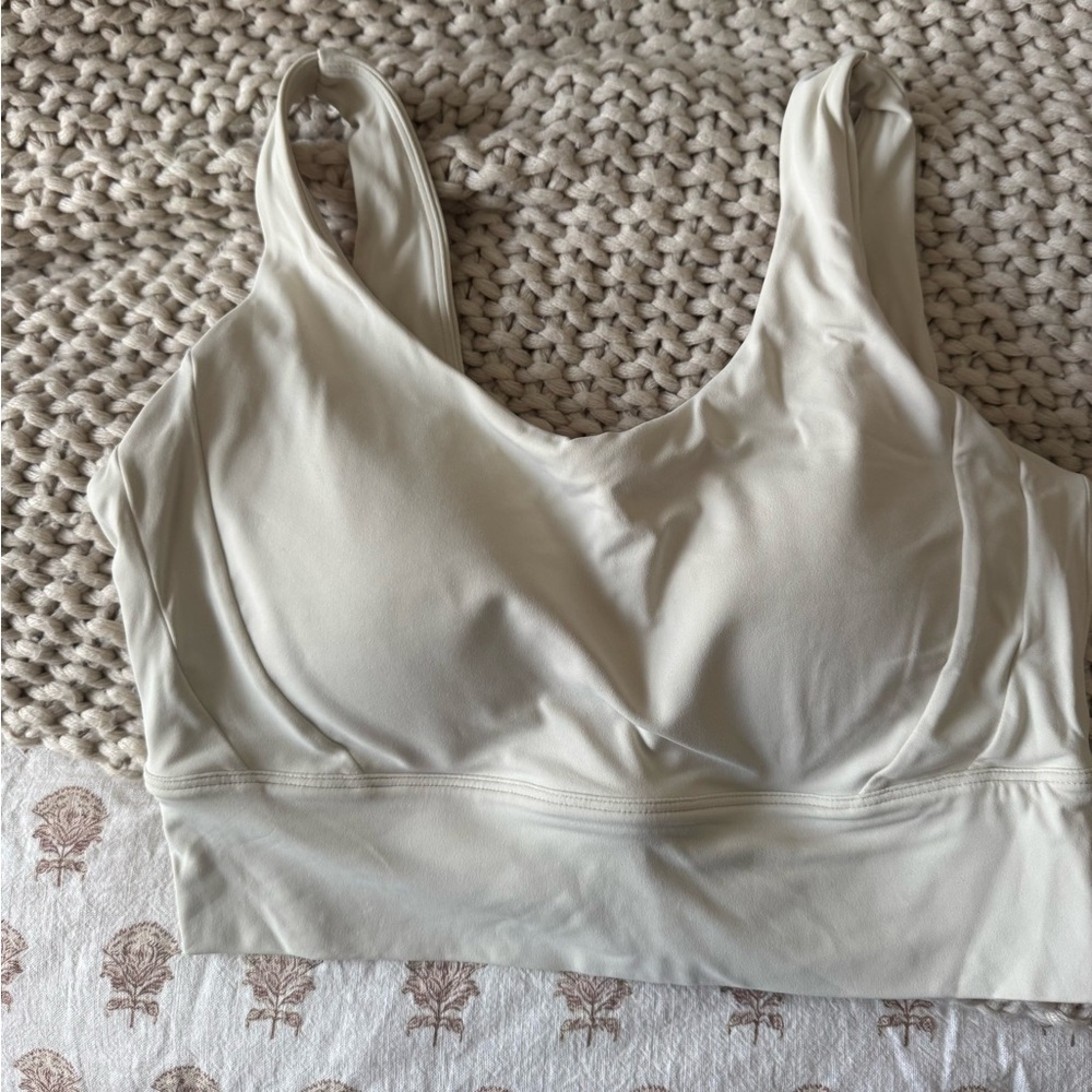 Cream U back workout tank, built in pads that are not removable.